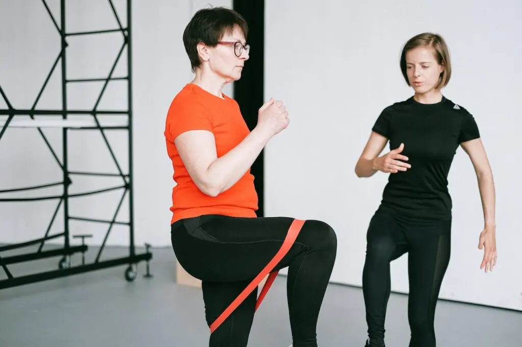 Physical therapist assisting patient with resistance‑band exercises